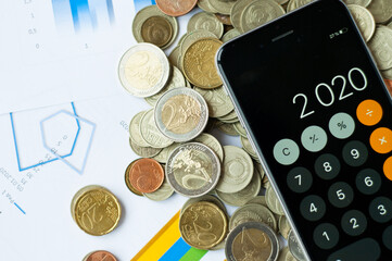 Top view of papers, pen, calculator, coins and glasses on table, European Currency - Banknotes and Coins