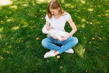 Happy family in the fresh air, mother with a baby in her arms