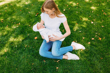 Fototapeta premium Happy family in the fresh air, mother with a baby in her arms