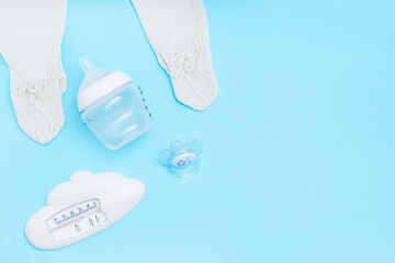 Cute baby accessories on blue background . Copy space Top view Flat lay