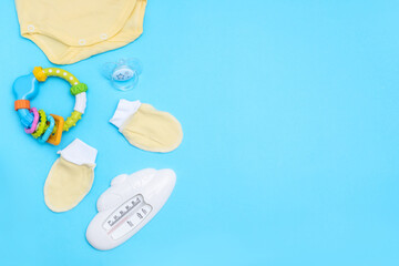 Lovely baby accessories on blue background . Copy space Top view Flat lay.