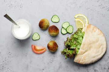 Falafel and fresh vegetables in pita bread. Healthy fast food. Close up view