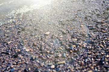 Sea pebble gravel beach. View from the top. Selective focus, toned colores.