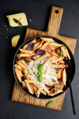 Penne pasta with eggplant, tomatoes and parmesan cheese. Traditional italian food