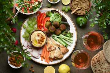 Festive dinner table with hummus plate and appetizers. Meze party food. Top view, flat lay