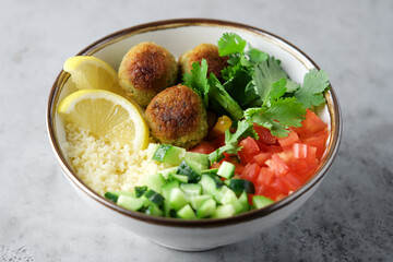 Falafel and couscous vegetables salad in bowl. Tabouleh salad Buddha bowl. Vegetarian, diet food concept