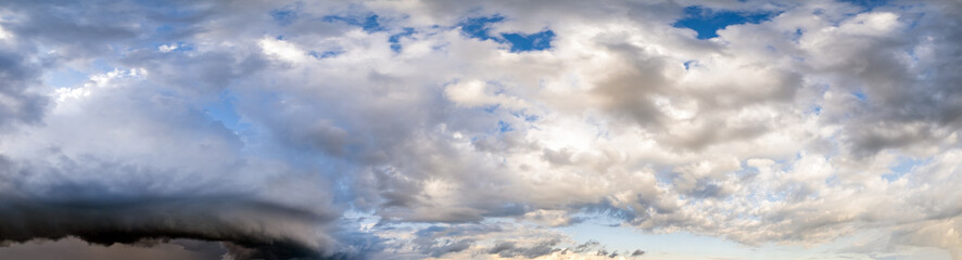 Dramatic cloudy sky with circular thunderstorm cloud in far