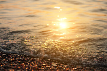 Obraz premium Sea surf on sunset time. Black Sea coast. Pebble washed by sea waves.