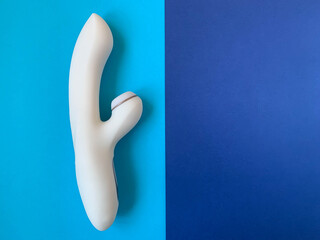 Sex toy. White Vibrator on a blue background. Useful for adult, sex shop