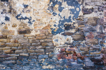 Detail shot of an old brick wall and crumbling cement