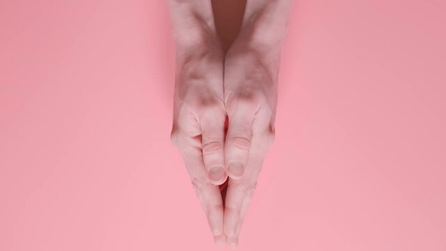 small red paper boat in female palms. conceptual abstract image of the vagina