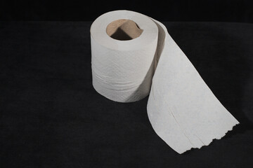 Toilet paper roll on a black background.