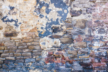 Detail shot of an old brick wall and crumbling cement