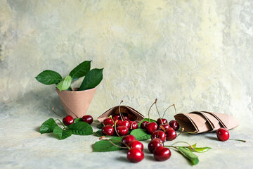 Origami paper cups with cherries. Eco-friendly food packaging, on an abstract beautiful background with a copy space. The preservation of nature and the concept of recycling. selective focus.