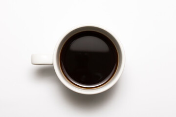 Obraz na płótnie Canvas top view a cup of espresso black coffee isolated on white background