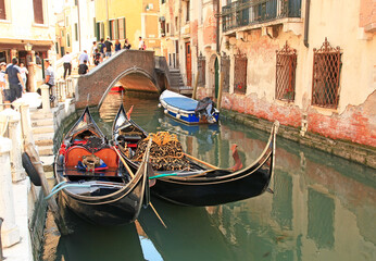 Gondolas in a small canal in Venice, Italy.