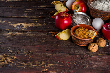 Autumn baking concept. Cooking baking background with ingredients, spices and utensils. All you need for baking traditional autumn apple pie, on rustic wooden background copy space