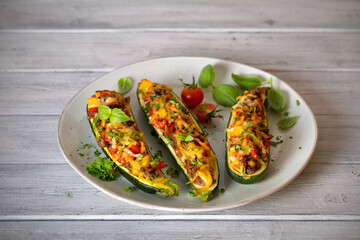 Zucchini stuffed with meat, vegetables and cheese. Zucchini boats. Loaded zucchini. Horizontal image