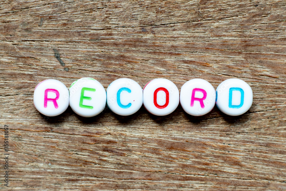 Canvas Prints White bead with color letter in word record on wood background