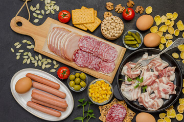 Bacon, sausages, cheese, vegetables, cookies, cereal yogurt: ingredients for continental breakfast.