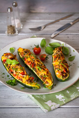 Zucchini stuffed with meat, vegetables and cheese. Zucchini boats. Loaded zucchini. Vertical image