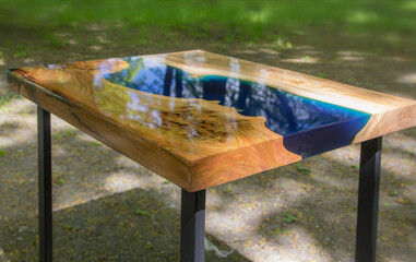 Beautiful wooden table made of elm slab with epoxy resin filling