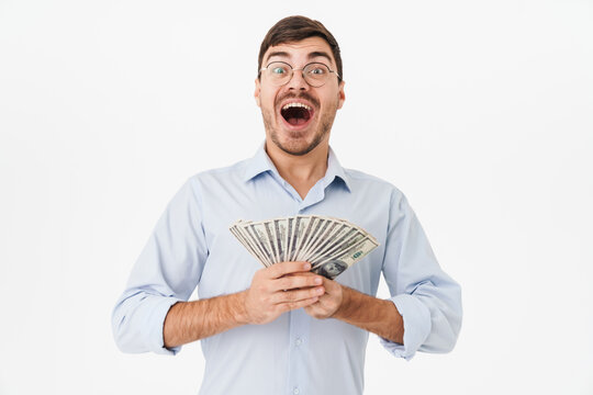 Photo of delighted man holding dollars and expressing surprise