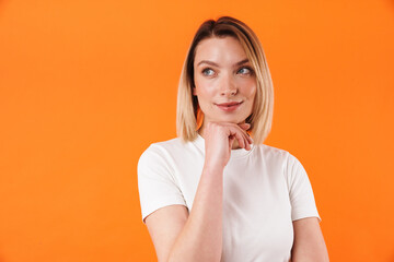 Image of pleased caucasian woman posing and looking aside
