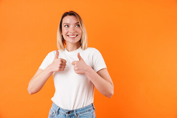 Image of joyful caucasian woman smiling and gesturing thumbs up