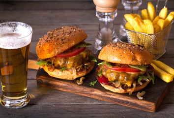 Beef burger in classic american style with hot grilled patty, melted cheese on top, tomato, onion,...
