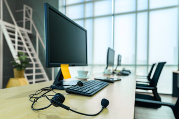 We pride ourselves in delivering quality customer services. Shot of a group of young call centre agents wearing headsets and working on their computers in an office.