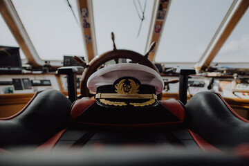 Captains hat left on the captains char on an old ship