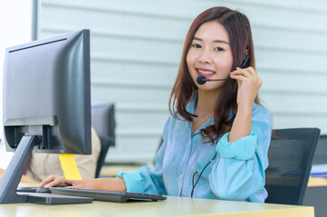Smiling female operator working in call center. Cropped portrait of an attractive young businesswoman wearing a headset while in the office during the day
