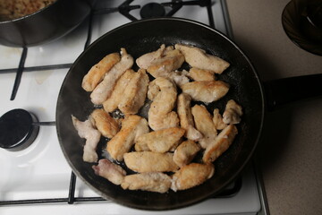 Pieces of chicken fillet fried in a pan. Cooking Sliced ​​Chicken Fillet.