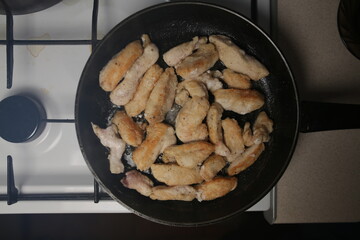 Pieces of chicken fillet fried in a pan. Cooking Sliced ​​Chicken Fillet.