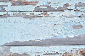 Wooden background made of old boards with spots of old white paint.