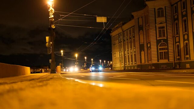 4k. night drive on empty city street road from the window of speed car, steet light blurring after rain.