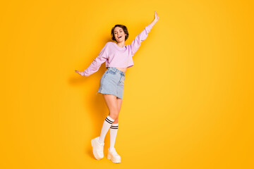 Full size photo of cute pretty content teen girl enjoy autumn free time weekend holiday raise hands wear good look outfit isolated over vivid color background