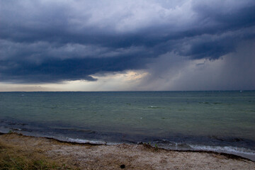 Before storm and rain on the sea. On the island. Nature. Coast of the ocean. Dark clouds. 