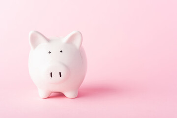 Front small white fat piggy bank, studio shot isolated on pink background and copy space for use, Finance, deposit saving money concept