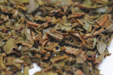 Loose black tea leaves used after brewing tea with it, isolated, white background