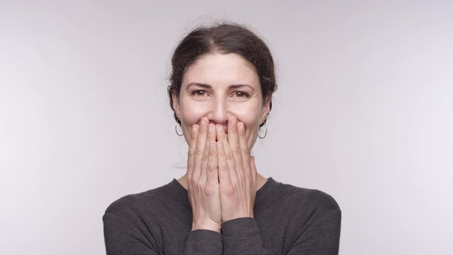 Portrait of a beautiful middle aged woman of Spanish is full of happiness and thankful on a studio backdrop