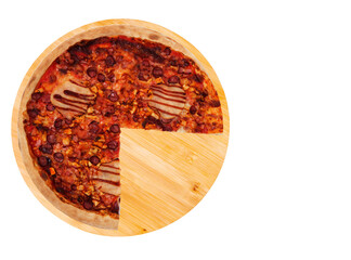 Delicious BBQ pizza with ham, bbq sauce, bacon and salami, without a quarter on a round wooden platter, isolated on white background, top view