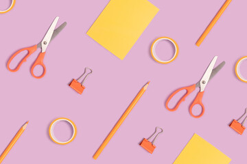 Pattern made of stationery on a purple pastel background. Back to school concept.