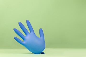 Latex surgical gloves inflated like balloons on a green background