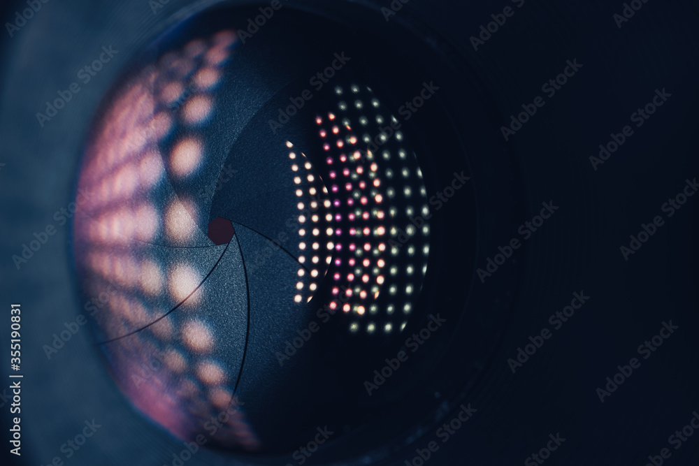 Aufkleber close up beautiful camera lens on a dark with pink reflection light background. macro view.