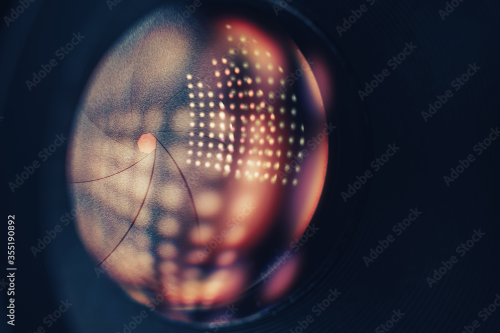 Poster beautiful camera lens on a dark with yellow shine reflection light background. macro view.