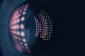 Close up Beautiful Camera Lens on a dark with pink reflection light background. Macro view.