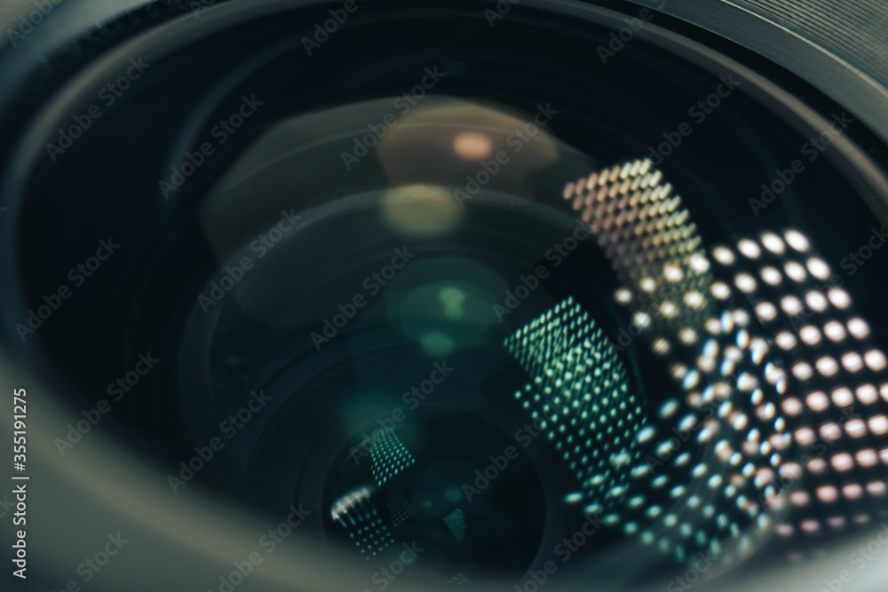 Poster close up beautiful camera aperture lens with multi colored light glass reflection. macro view.