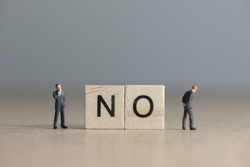 Wooden tiles with letters spelling out the word No. Business concept